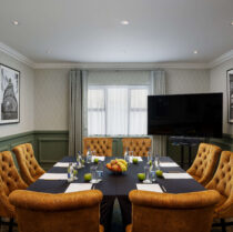 Cosy meeting room with plush seating and table set for conference at Springfield Hotel.