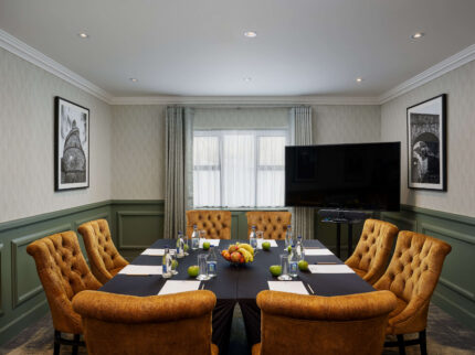 Cosy meeting room with plush seating and table set for conference at Springfield Hotel.