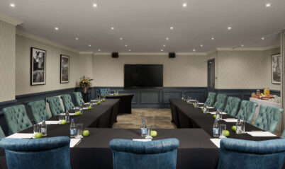 Elegant conference room with long tables set up for a meeting at Springfield Hotel.