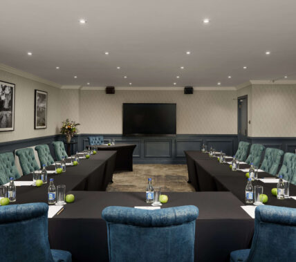 Elegant conference room with long tables set up for a meeting at Springfield Hotel.