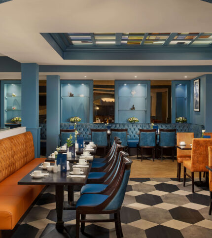 Elegant hotel dining area with welcoming seating and warm lighting.