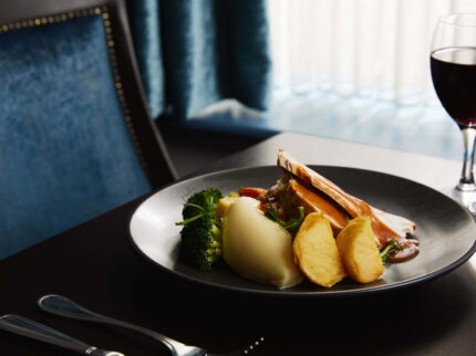 Elegant dining setting with gourmet meal and glass of wine at Springfield Hotel.