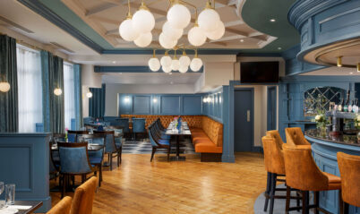 Chic hotel dining area with families gathered under modern chandeliers.