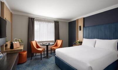 Cosy hotel room with king-size bed and seating area for relaxation.