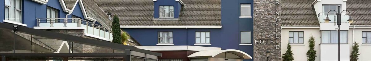 Family enjoys Springfield Hotel entrance, blue facade with welcoming outdoor seating area.