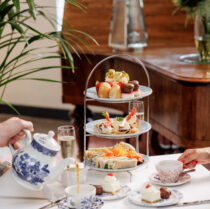 Family enjoying afternoon tea with pastries at a Springfield Hotel lounge.