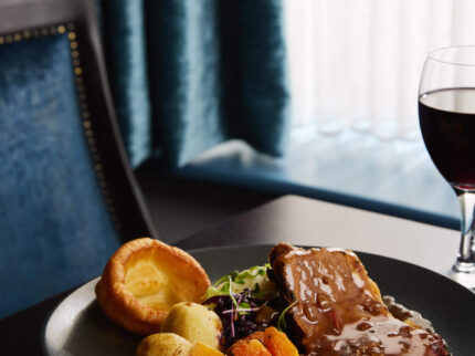 Cosy dining setting with delicious roast dinner on table at Springfield Hotel.