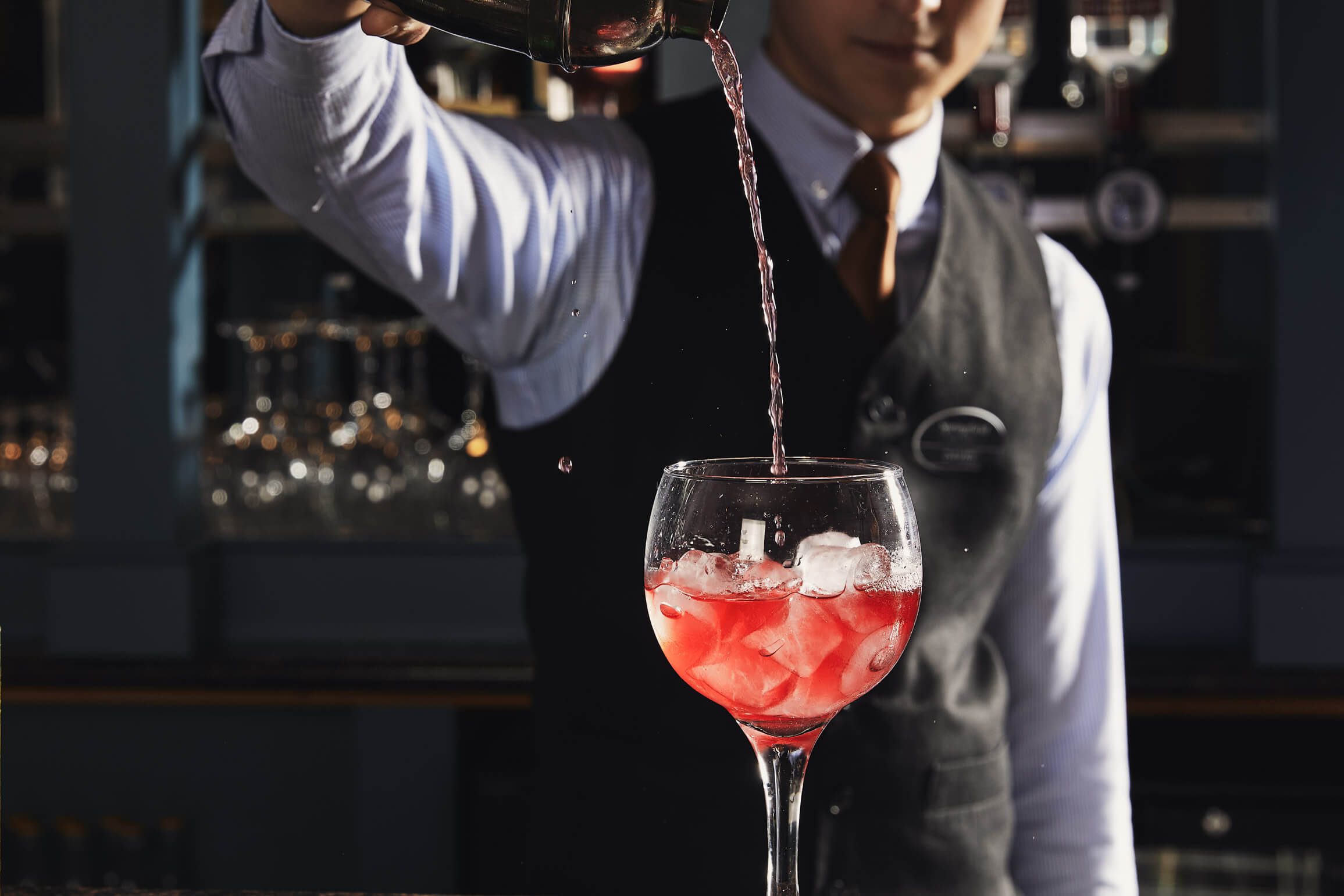 Bartender serving a refreshing cocktail at Springfield Hotel bar.
