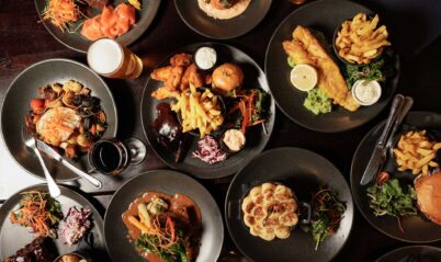 A table with assorted gourmet dishes and drinks, creating a delicious dining experience.