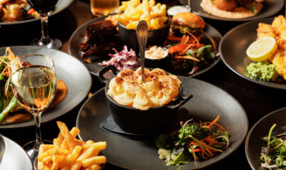 A lively family enjoys a hearty meal at Springfield Hotel's elegant restaurant.