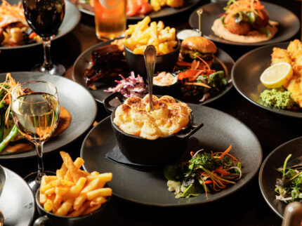 A lively family enjoys a hearty meal at Springfield Hotel's elegant restaurant.