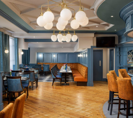 Elegant hotel dining area with cosy seating and a welcoming ambience.