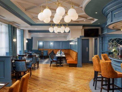 Elegant hotel dining area with cosy seating and a welcoming ambience.