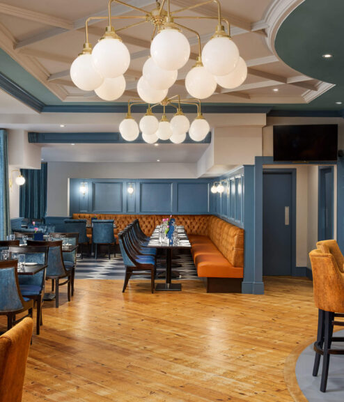 Elegant hotel dining area with cosy seating and a welcoming ambience.