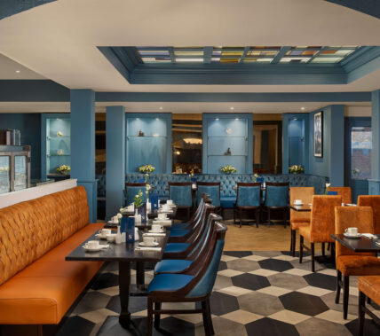 Family dining in a cosy hotel restaurant with warm blue décor.