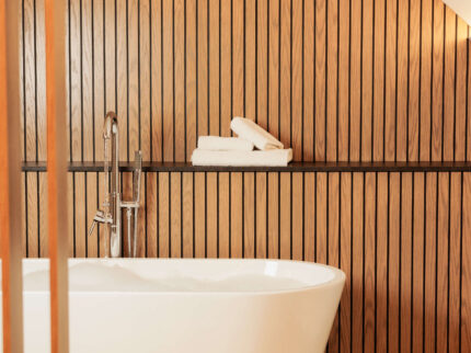 Elegant bathroom with a freestanding tub and wooden panelling at Springfield Hotel.