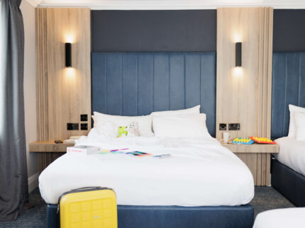 Family-friendly hotel room with twin beds and soft lighting, in Springfield Hotel.