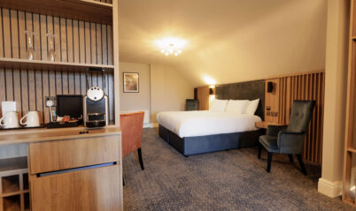 Spacious Springfield Hotel room with a large bed and cosy seating area, offering a warm and inviting atmosphere.