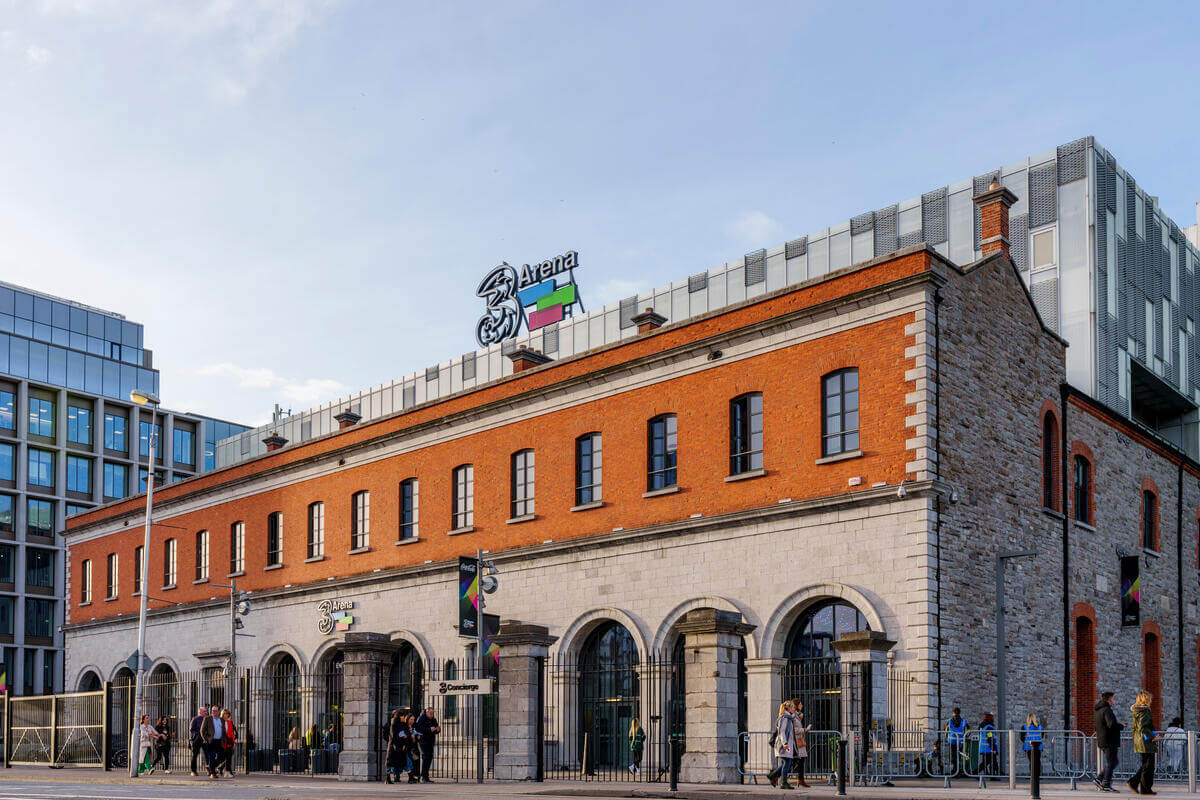 A family strolls outside the historic Springfield Hotel building in a lively urban setting.