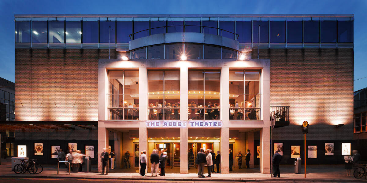 Families and couples gather outside the illuminated Springfield Hotel, enjoying an evening event.