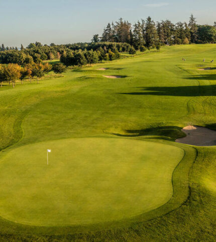 Family enjoying golfing on a lush, scenic course at Springfield Hotel.