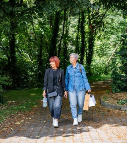 Couple strolls through lush garden path at Springfield Hotel