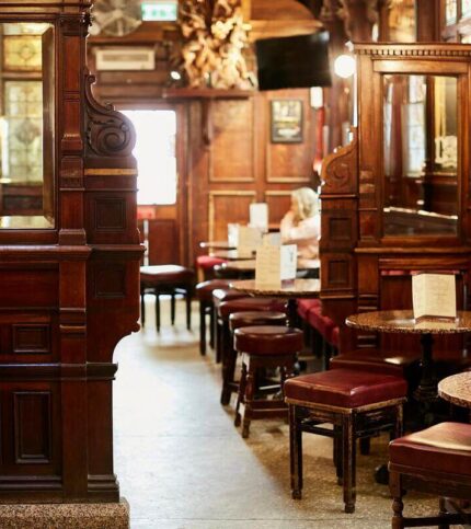 Cosy hotel lounge with wooden interiors and plush seating, family enjoying a relaxing moment.