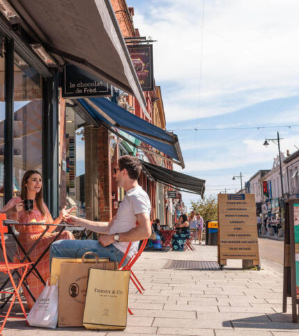 Family enjoying outdoor café in Springfield Hotel's vibrant street setting.