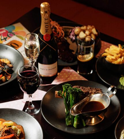 Elegant dining with champagne and gourmet dishes at Springfield Hotel.