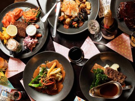 A family enjoys a gourmet meal at Springfield Hotel, with elegant dishes and festive decor.