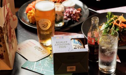 A family table with drinks and a vibrant dinner setting at Springfield Hotel.