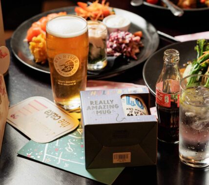 A family table with drinks and a vibrant dinner setting at Springfield Hotel.