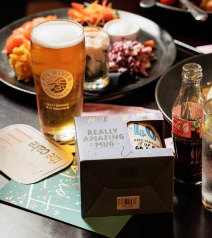 A family table with drinks and a vibrant dinner setting at Springfield Hotel.