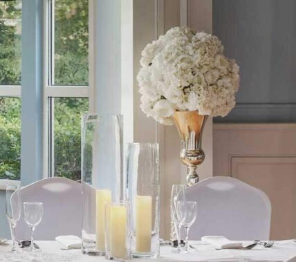 Elegant dining setup with candles in a bright, inviting Springfield Hotel room.