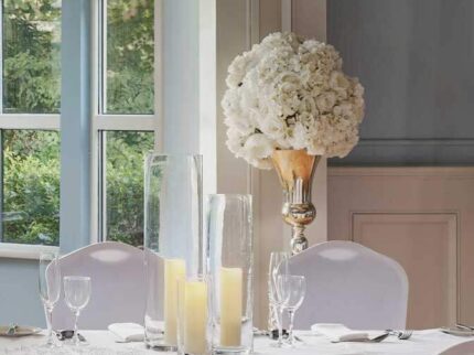 Elegant dining setup with candles in a bright, inviting Springfield Hotel room.
