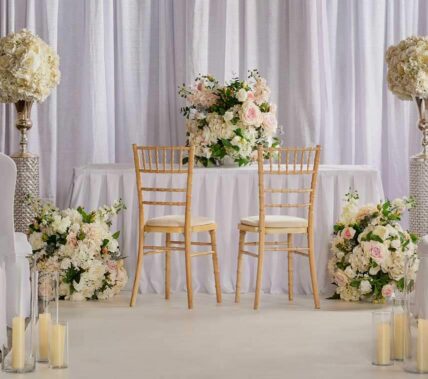 Elegant wedding setup with floral arrangements and two chairs in Springfield Hotel.