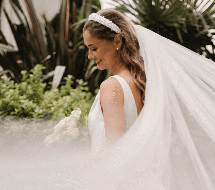 Smiling bride in a lush garden at Springfield Hotel.
