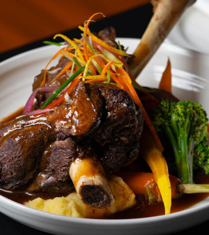 Gourmet dinner with lamb shank at Springfield Hotel restaurant setting.