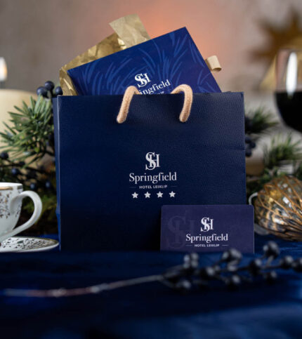 Elegant Springfield Hotel gift bag with tea and candles on a beautifully set table.