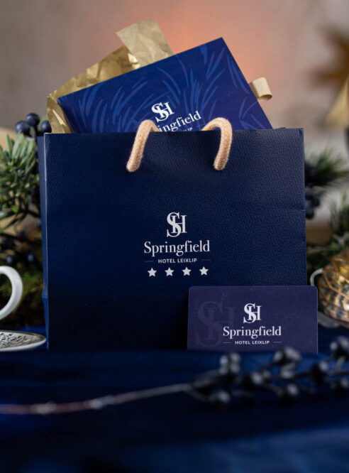 Elegant Springfield Hotel gift bag with tea and candles on a beautifully set table.