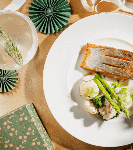 Elegant dining table with gourmet fish dish and festive decorations at Springfield Hotel.